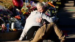 Justice Lord, left, gets comforted by a friend at a makeshift memorial near Club Q on November 20, 2022 in Colorado Springs, Colorado. 