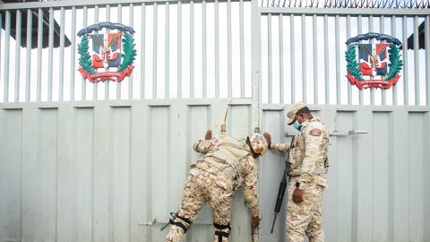 Members of the Specialized Border Security Corps (Cesfront) open the entry gate at the Dajabon and Ouanaminthe border bridge in Dajabon, Dominican Republic, on Sunday, Aug. 14, 2022. 