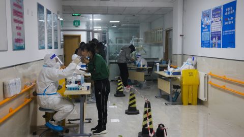 People wait in line for a swab test at a Covid-19 test center on November 20, 2022 in Beijing. 