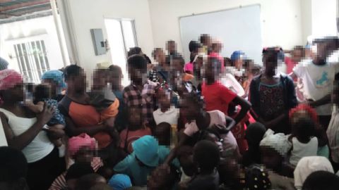 An image provided to CNN by the Haitian aid organization Groupe d'Appui des Rapatriés et Réfugiés shows people deported from the Dominican Republic on November 17 near the Malpasse border crossing. CNN obscured parts of the image to preserve their privacy.
