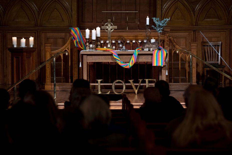 A Pride flag wraps around the altar during a vigil Monday at First Congregational Church in Colorado Springs.