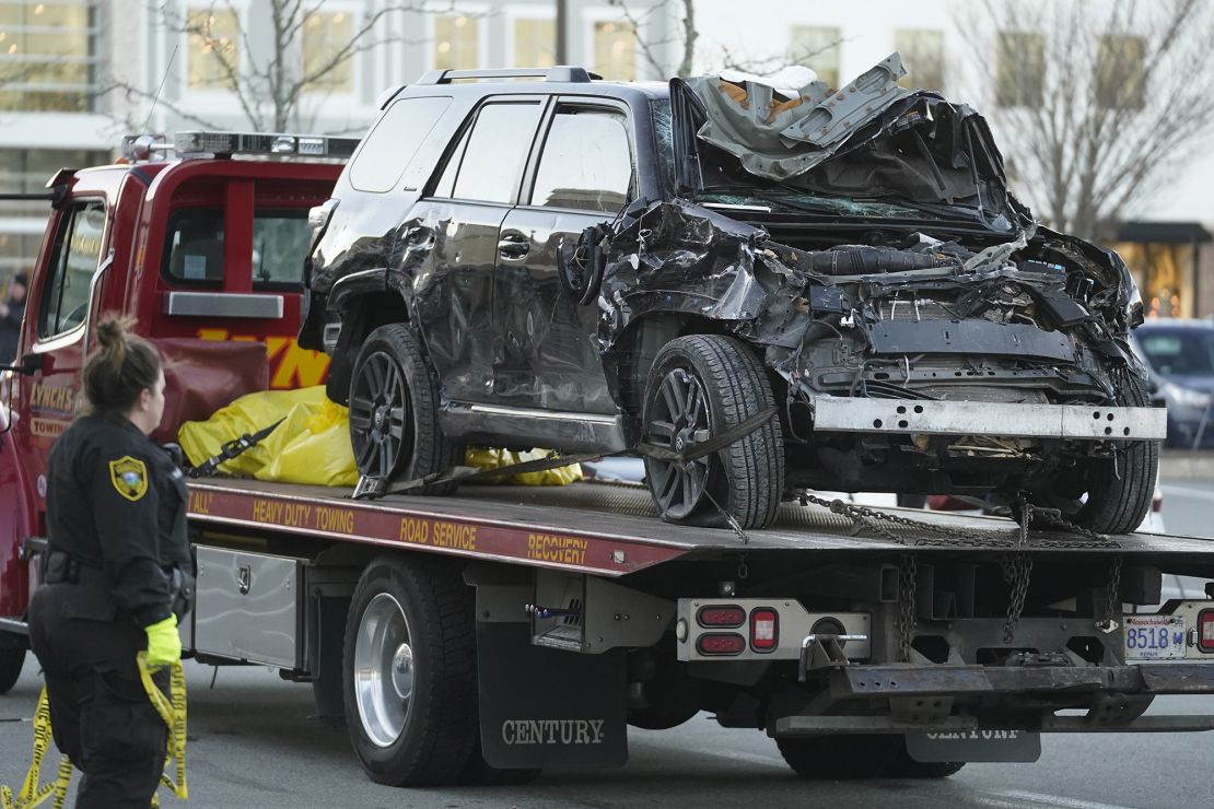 A tow truck removes the SUV from the scene of the crash.