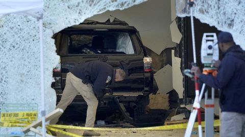 A law enforcement official examines the SUV in the Apple store in Hingham.