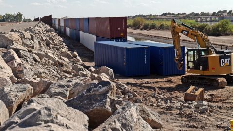 Shipping containers block a void in the wall as that prevent migrants attempting to cross in to the US from Mexico at the border August 19, 2022 in San Luis, Arizona. (Photo by Nick Ut/Getty Images)