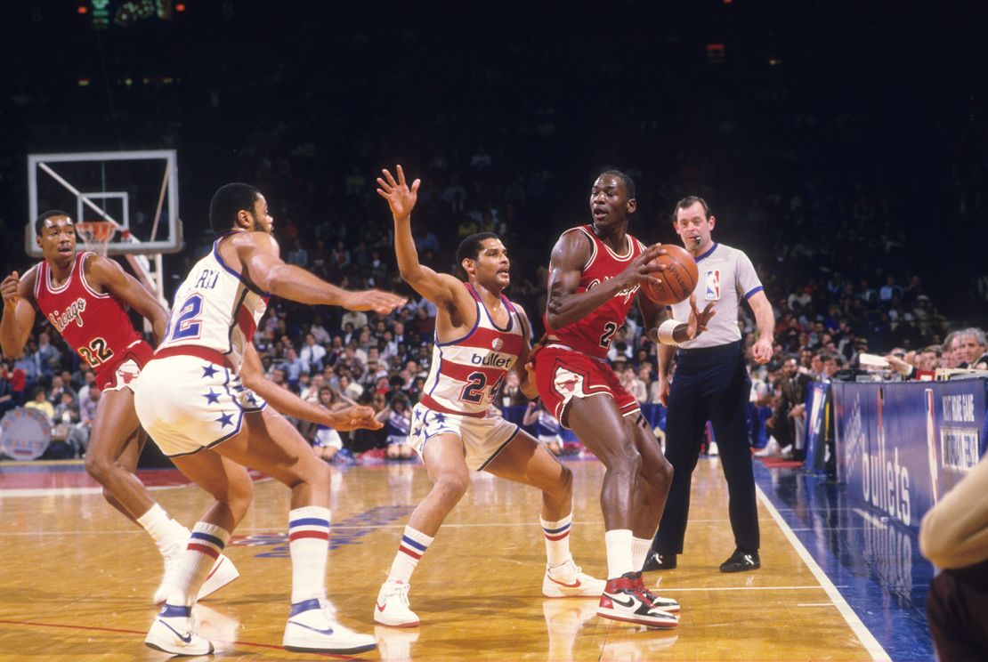 Chicago Bulls Michael Jordan (23) in action vs Washington Bullets Jeff Malone (24) at Capital Centre. Jordan wearing red Nike Air Jordan 1 sneakers.