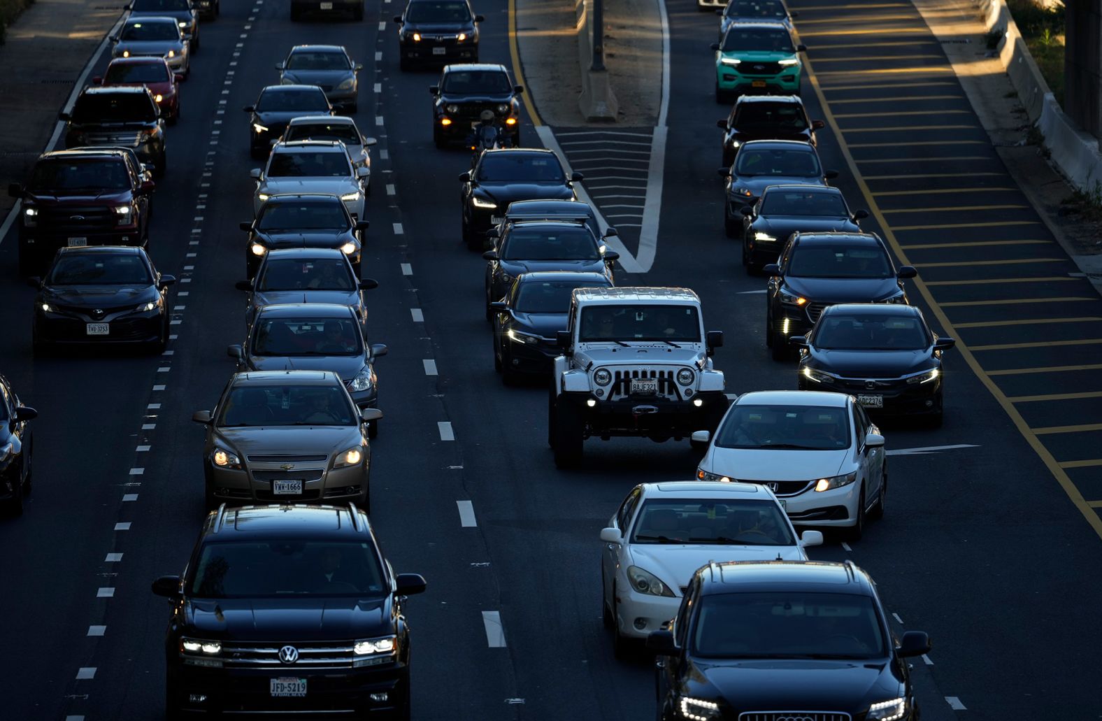 Heavy traffic moves along Interstate 395 in Washington, DC, on Tuesday. The American Automobile Association predicts nearly 55 million Americans will travel 50 miles or more for Thanksgiving this year.