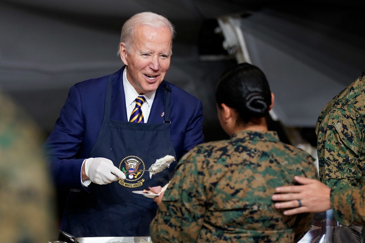 President Joe Biden serves food at a Thanksgiving dinner for military members and their families at an air station in Havelock, North Carolina, on Monday, November 21.