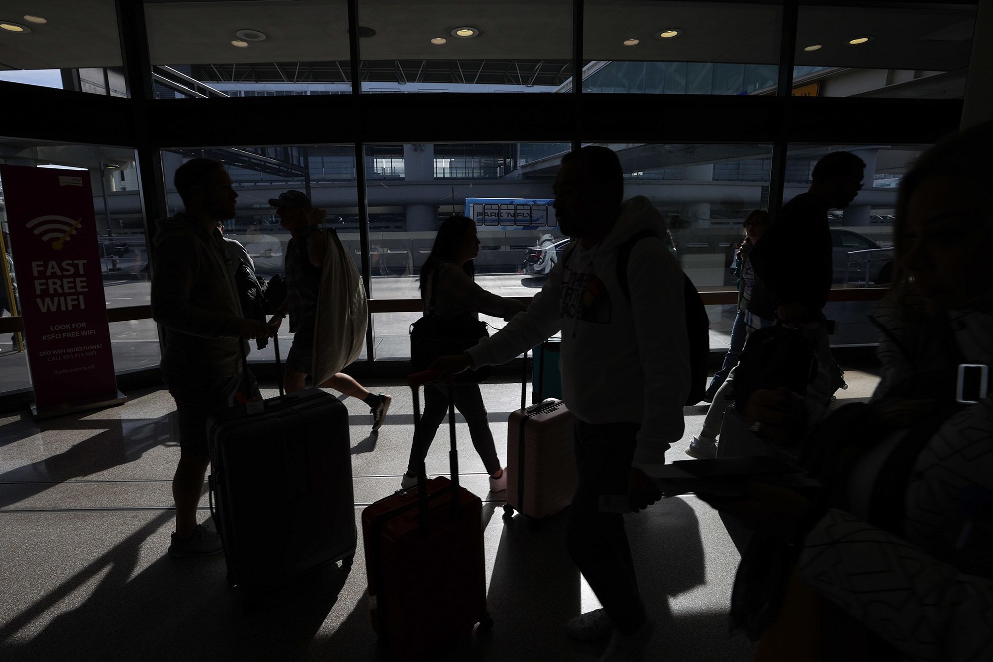 Travelers pass through San Francisco International Airport on Monday.