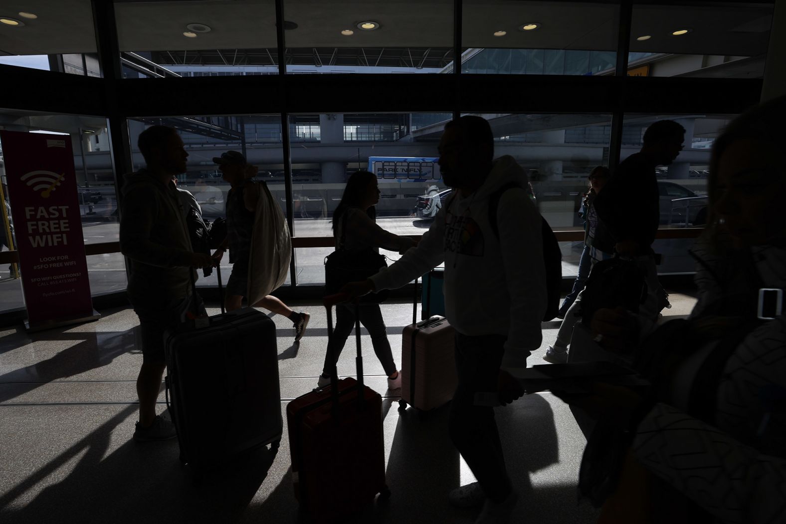 Travelers pass through San Francisco International Airport on Monday.