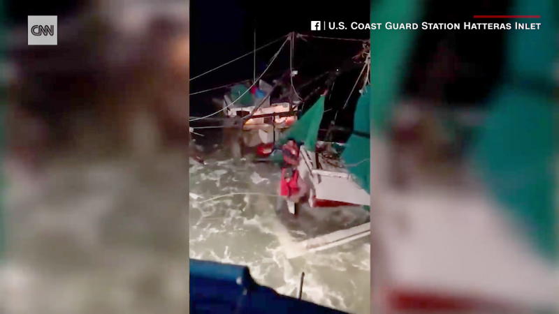 See dramatic rescue attempt as boat is swamped with raging water | CNN