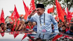 Malaysia's opposition leader Anwar Ibrahim, also the leader of the Pakatan Harapan (Alliance Of Hope) coalition, greets supporters as he leaves after submitting his nomination as a candidate on November 05, 2022 in Tambun, Perak, Malaysia. 