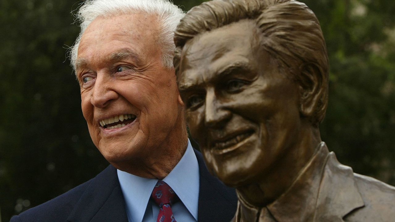 Bob Barker poses with his bust at the Academy of Television Arts and Sciences Hall of Fame.