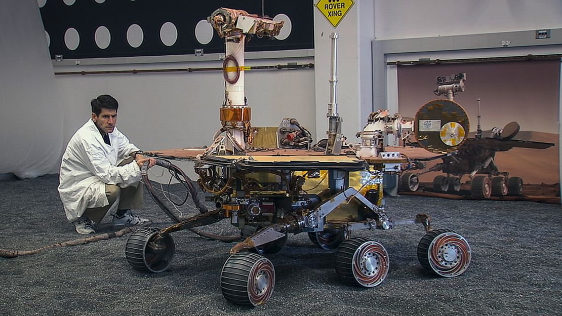 A mission team member inspects the NASA Opportunity rover. The team grew emotionally attached to the robotic Mars explorer and its twin, Spirit.