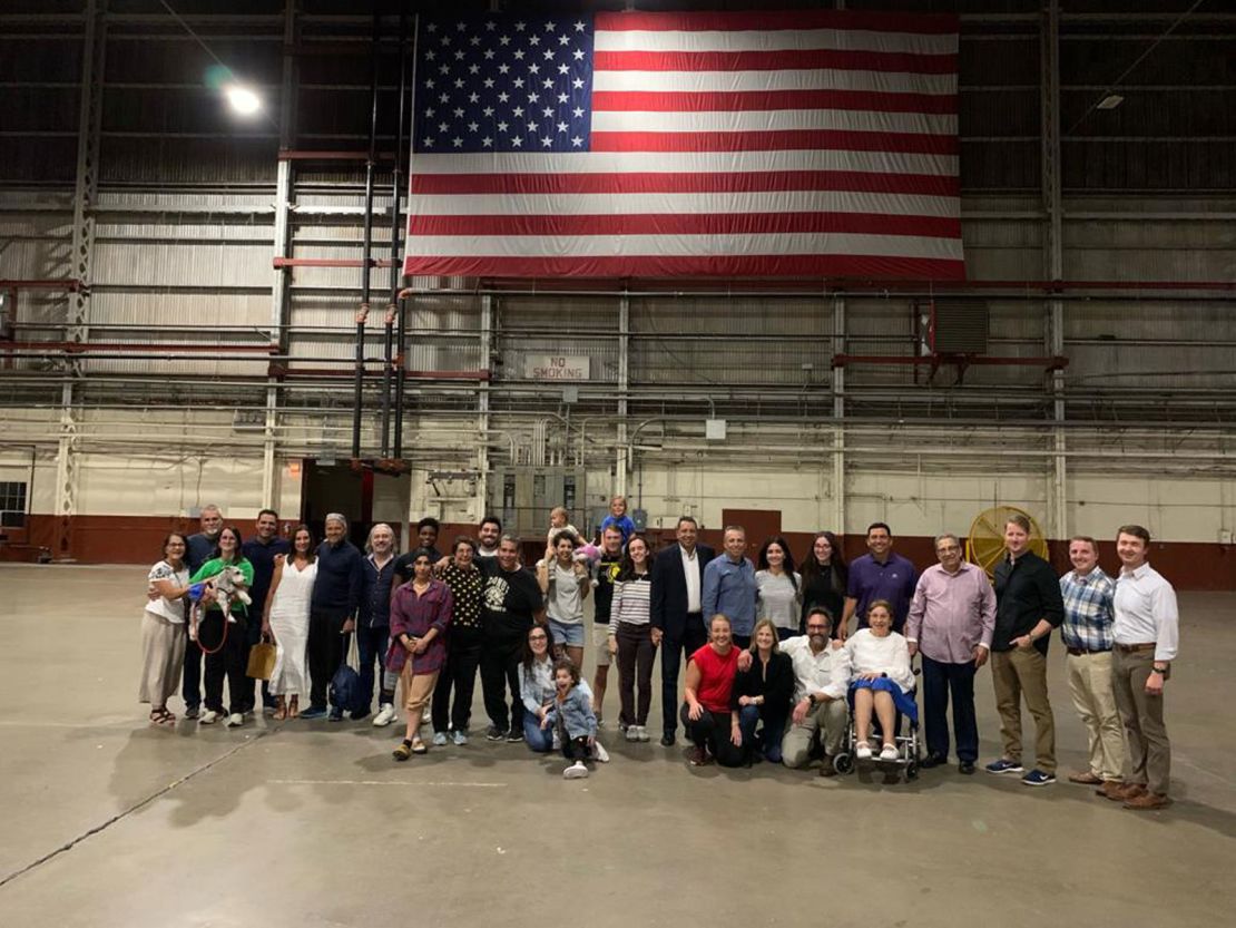 A group of seven Americans are pictured with their families and officials upon returning to the United States after being detained in Venezuela.