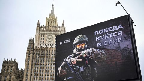 The Russian Foreign Ministry building can be seen behind a billboard displaying the letter 
