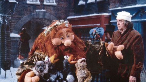 The Ghost of Christmas Present, left, and Michael Caine, right, in 1992's "The Muppet Christmas Carol."