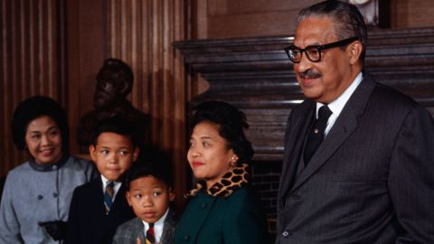 Thurgood Marshall stands with his family prior to being sworn in as the first black member of the US Supreme Court. Left to right are his sister-in-law, Mrs. Sally Acoba; sons, Thurgood, Jr. and John; and wife, Cecilia.