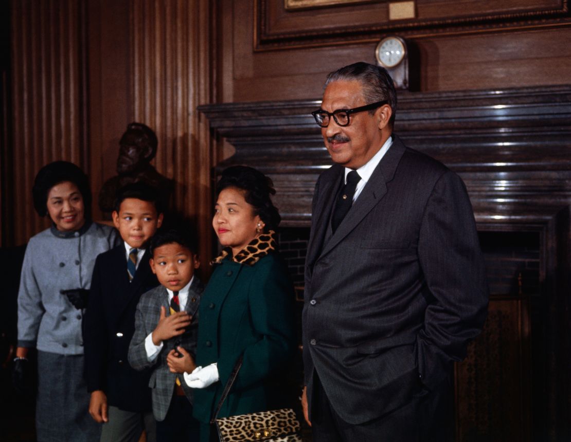 Thurgood Marshall stands with his family prior to being sworn in as the first black member of the US Supreme Court. Left to right are his sister-in-law, Mrs. Sally Acoba; sons, Thurgood, Jr. and John; and wife, Cecilia.