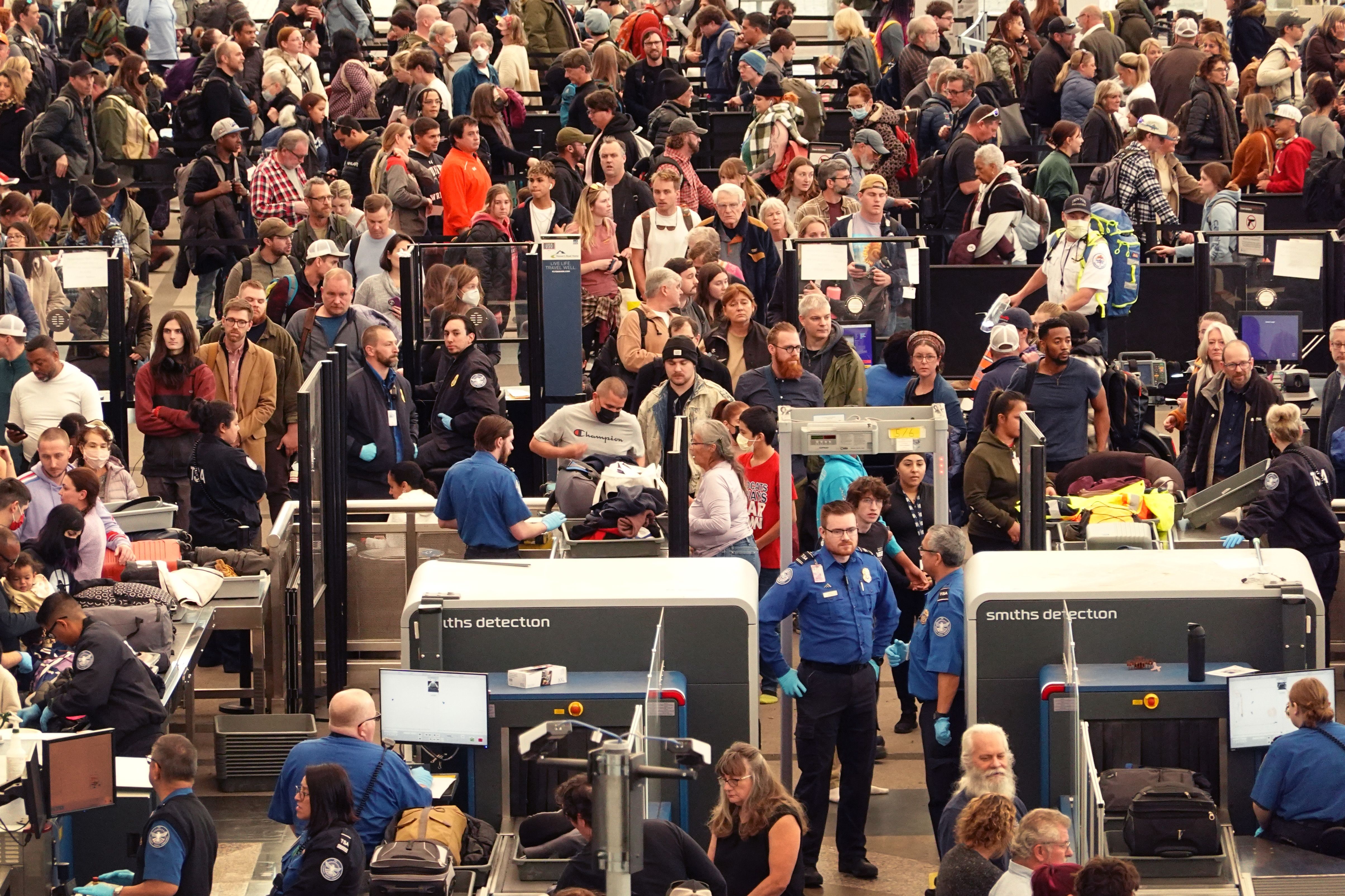 Travelers navigate a security checkpoint at Denver International Airport on Tuesday.