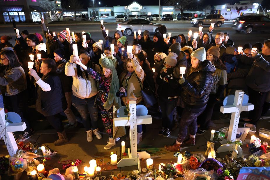 People gather at a makeshift memorial near the Club Q nightclub on Monday.