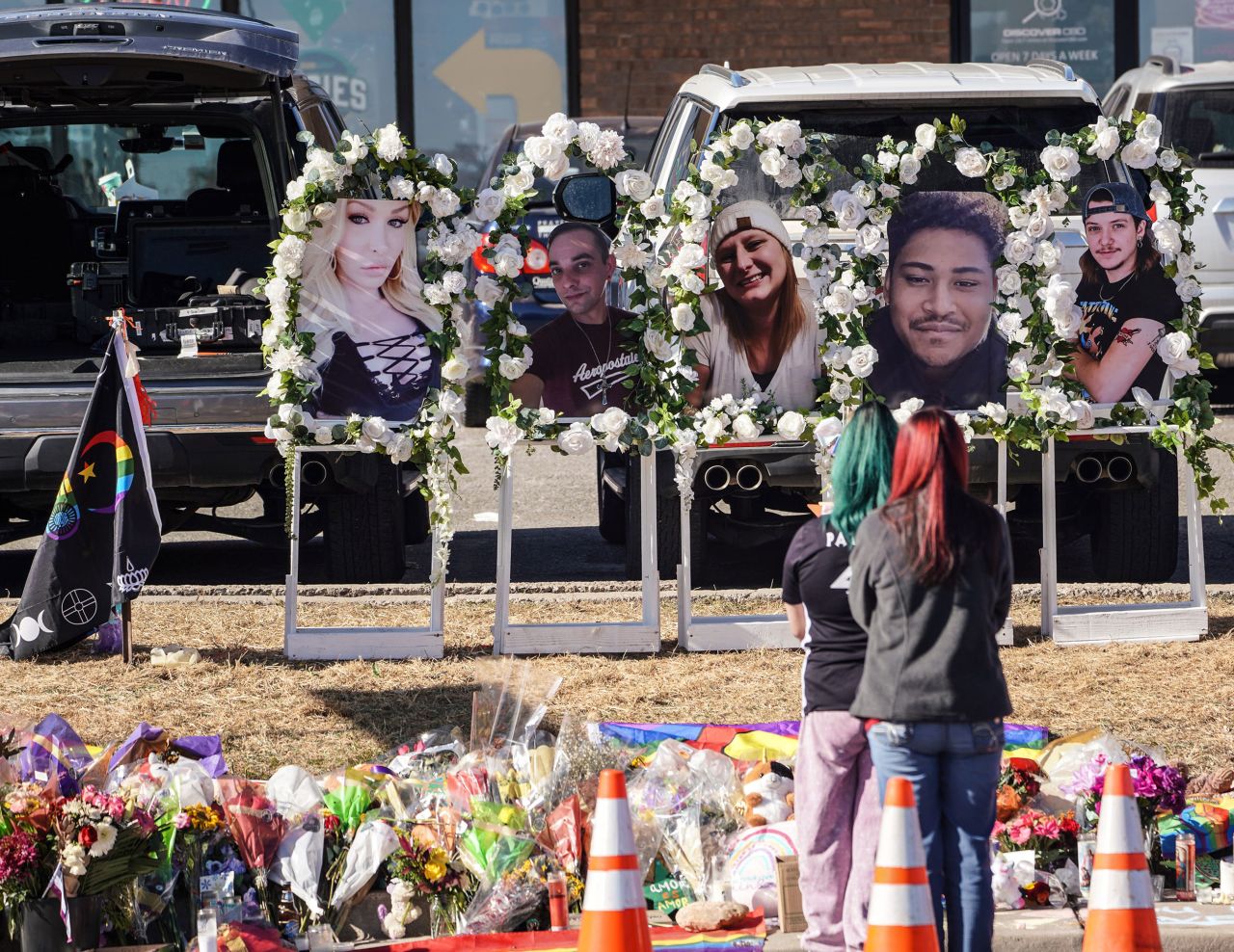 People pay their respects at a memorial display set up to remember the five victims of the Club Q shooting in Colorado Springs, Colorado, on Tuesday, November 22.