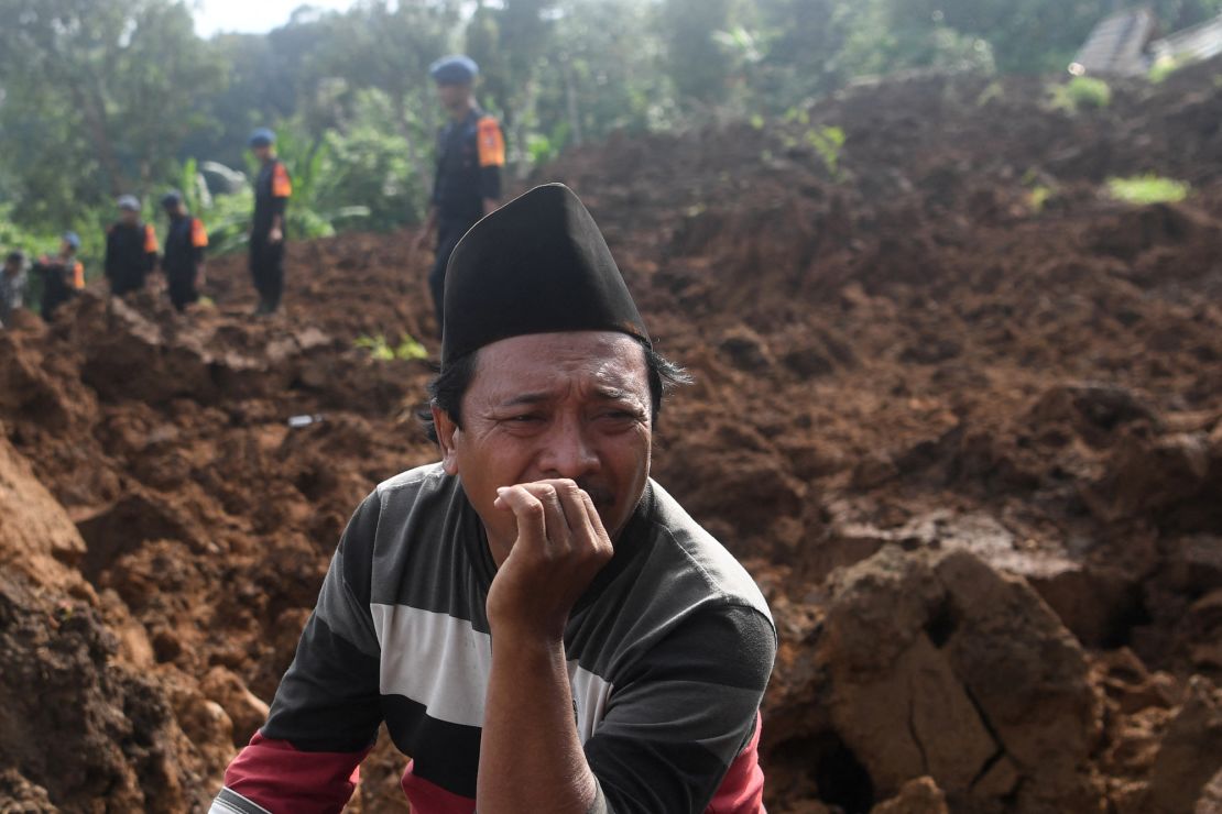 A man reacts as rescuers look for victims at an area affected by landslides after Monday's earthquake hit in Cianjur, West Java province, Indonesia, November 22, 2022.