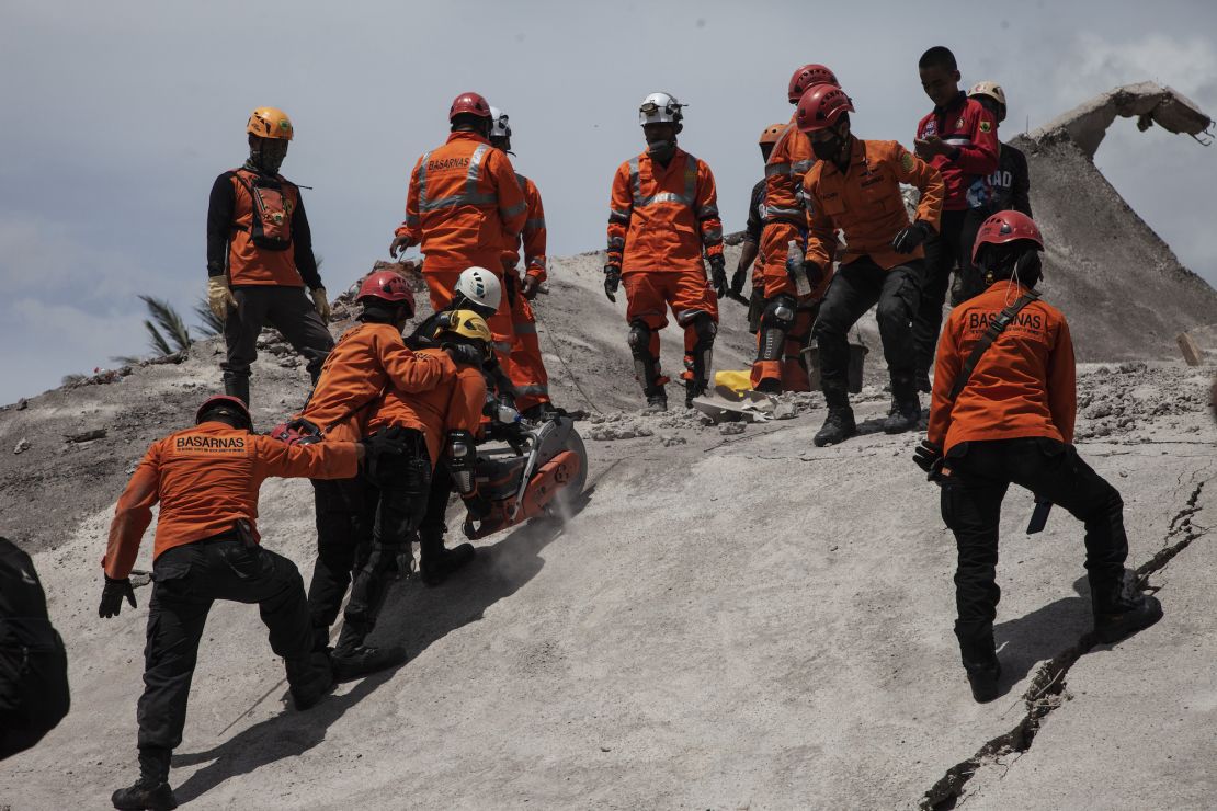 Indonesian search and rescue team evacuate the bodies from destroyed buildings in Cianjur Regency, West Java province, on November 22, 2022.