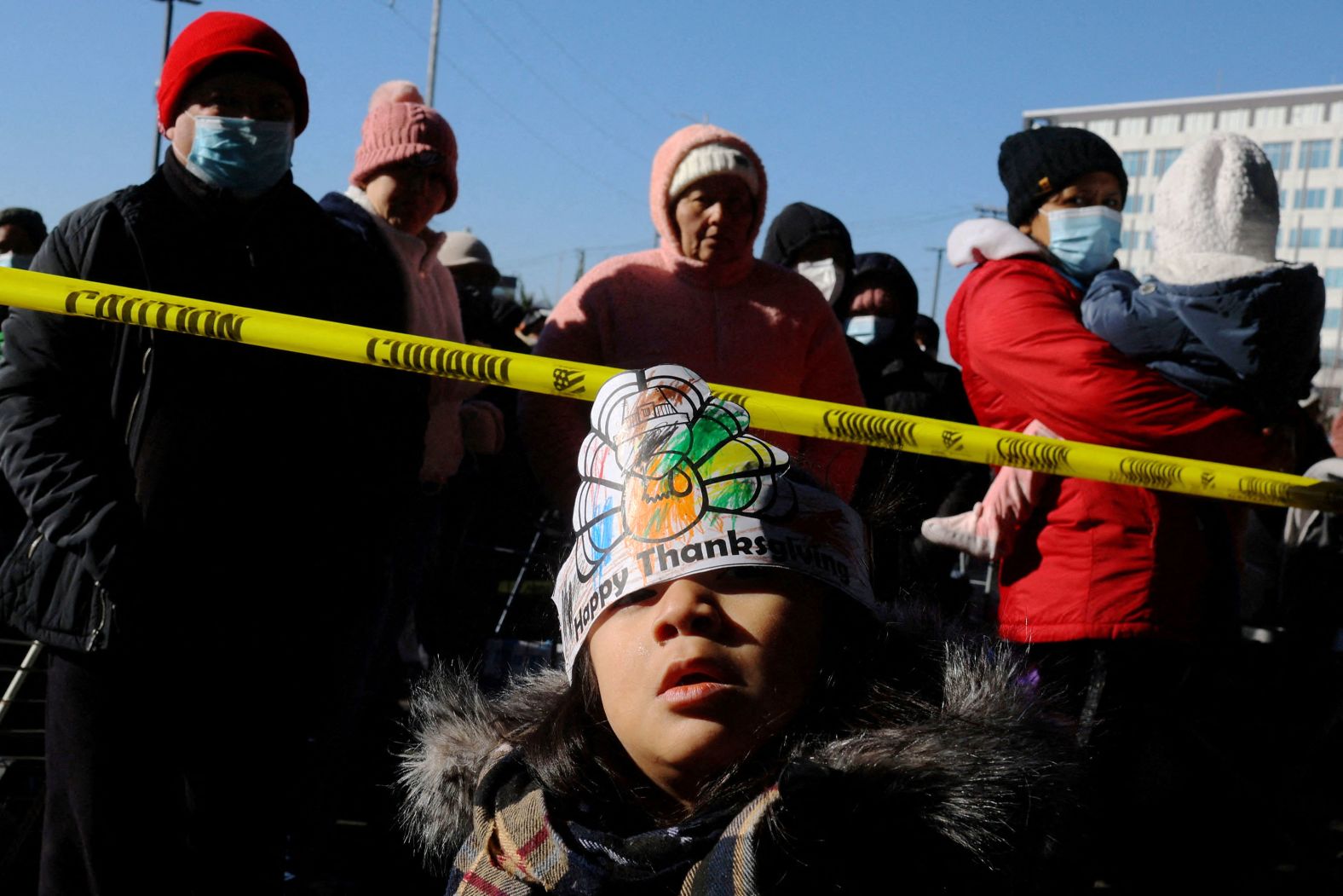 Eliana Chavez, 3, waits in line with her mother at La Colaborativa's Thanksgiving holiday food pantry, where an estimated 10,000 boxes of food were expected to be distributed to residents in Chelsea, Massachusetts, on Tuesday.