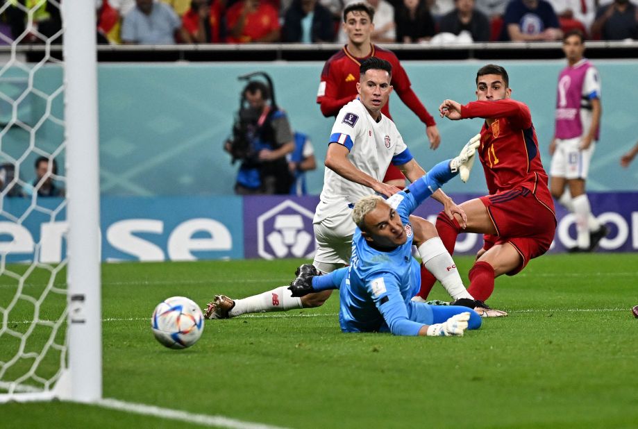Spain's Ferran Torres, right, shoots past Costa Rican goalkeeper Keylor Navas to give his team a 4-0 lead in their opening match on November 23. Spain went on to win 7-0.
