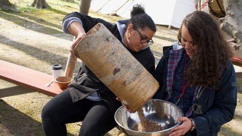 Taelor Barton (right) and Britt Reed prepare a southeastern tribal delicacy called kanuchi at the 2019 Intertribal Food Summit in Dowagiac, Michigan.