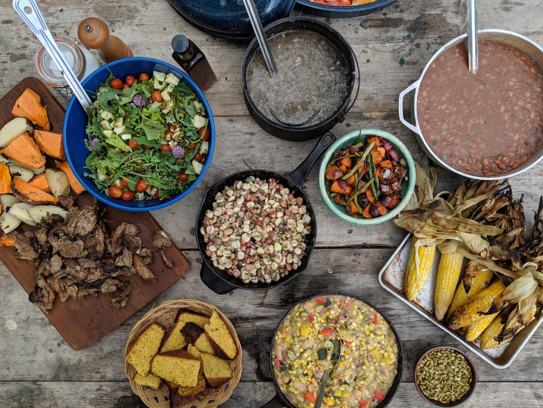 A spread of foods including fire roasted pig, sweet potatoes, hominy and mush, prepared by Barton and fellow chefs Nico Albert and Brad Dry.