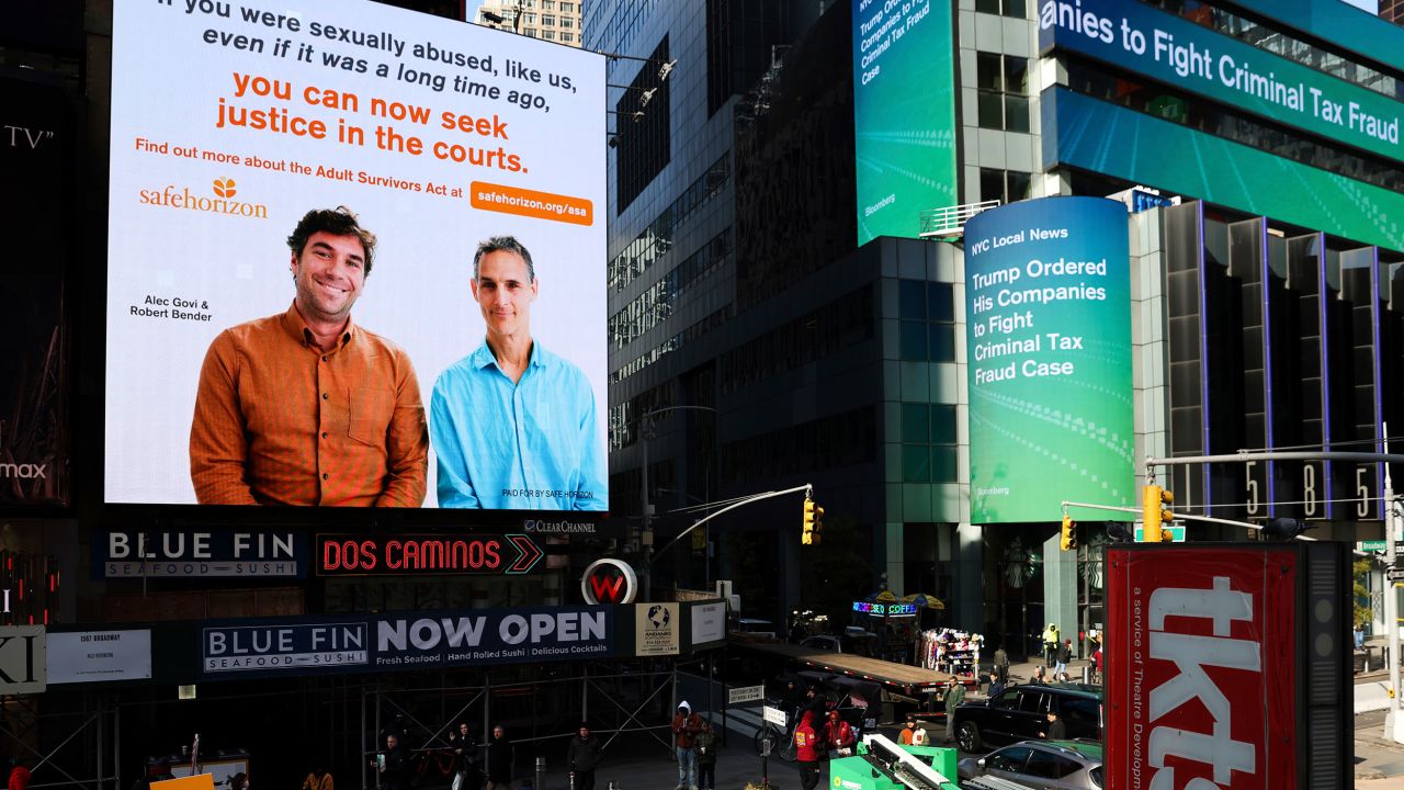 A public service announcement about the Adult Survivors Act plays Friday in Times Square in New York.