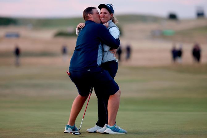 A stunned Ashleigh Buhai is embraced by husband David after she lifted <a href="index.php?page=&url=https%3A%2F%2Fwww.cnn.com%2F2022%2F08%2F11%2Fgolf%2Fashleigh-buhai-womens-british-open-muirfield-spt-intl%2Findex.html" target="_blank">her first major title</a> on her 221st career LPGA start at the Women's British Open in August. 