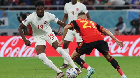 Canada forward No. 19 Alphonso Davies battles for the ball with Belgium defender Timothy Castagne.