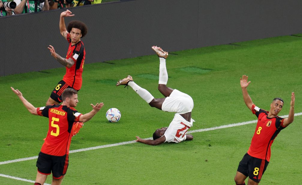Belgian players insist there is no foul as Canada's Richie Laryea tumbles over in the box.