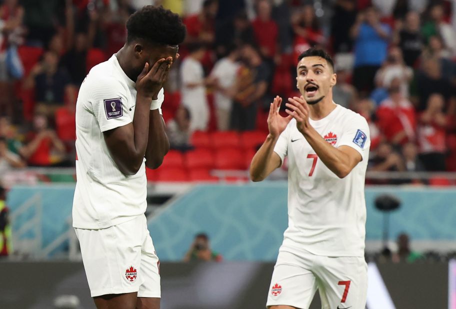 Canada's Alphonso Davies, left, reacts after missing a penalty early in the first half against Belgium.
