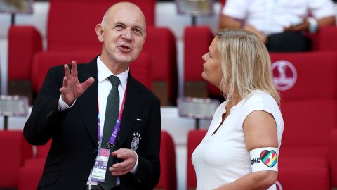 German Football Association President Bernd Neuendorf (L) and German Federal Minister of the Interior and Community Nancy Faeser, who is wearing a "OneLove" armband, speak during the World Cup game between Germany and Japan at Khalifa International Stadium on November 23, 2022 in Doha, Qatar.