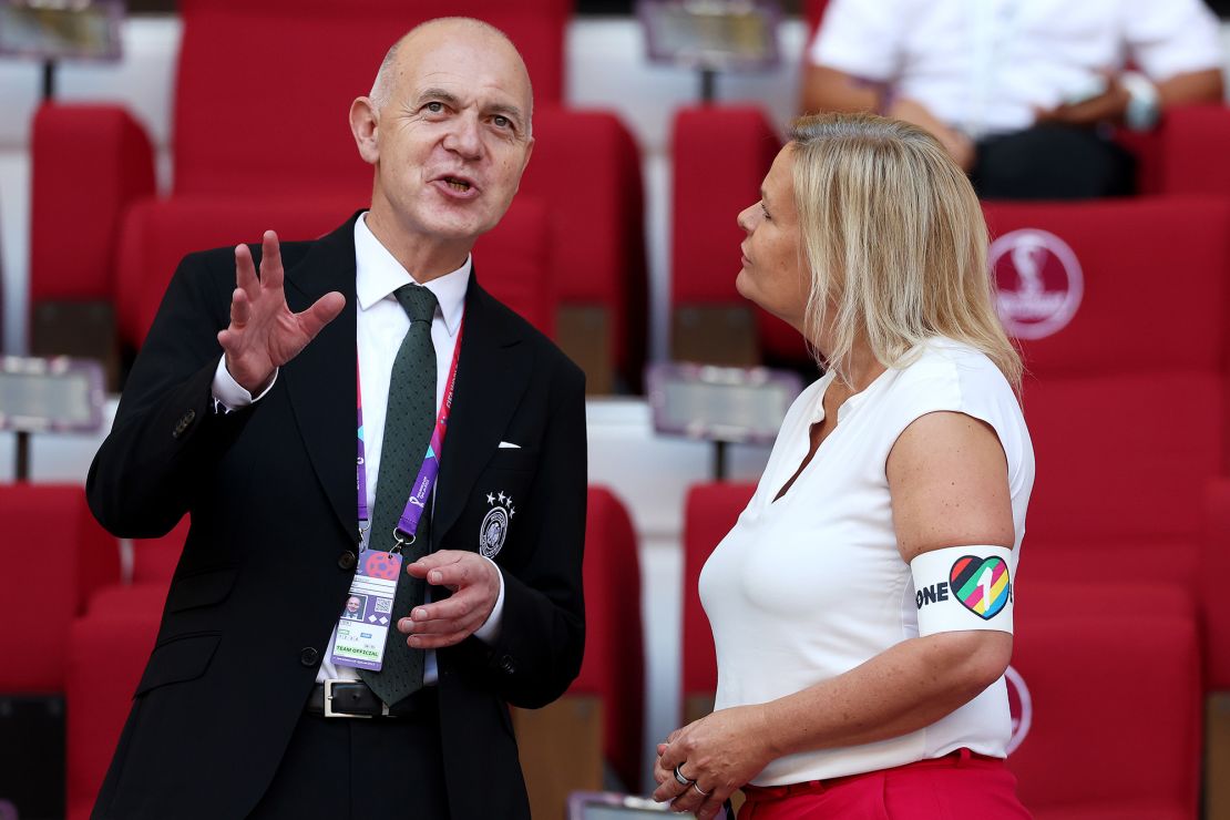 German Football Association President Bernd Neuendorf (L) and German Federal Minister of the Interior and Community Nancy Faeser, who is wearing a "OneLove" armband, speak during the World Cup game between Germany and Japan at Khalifa International Stadium on November 23, 2022 in Doha, Qatar.