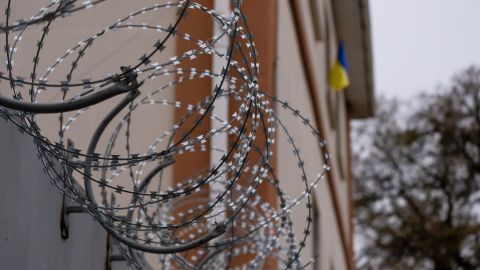 The Ukrainian flag hangs atop a detention center used by Russian forces to hold and torture Ukrainian soldiers, dissidents and partisans.