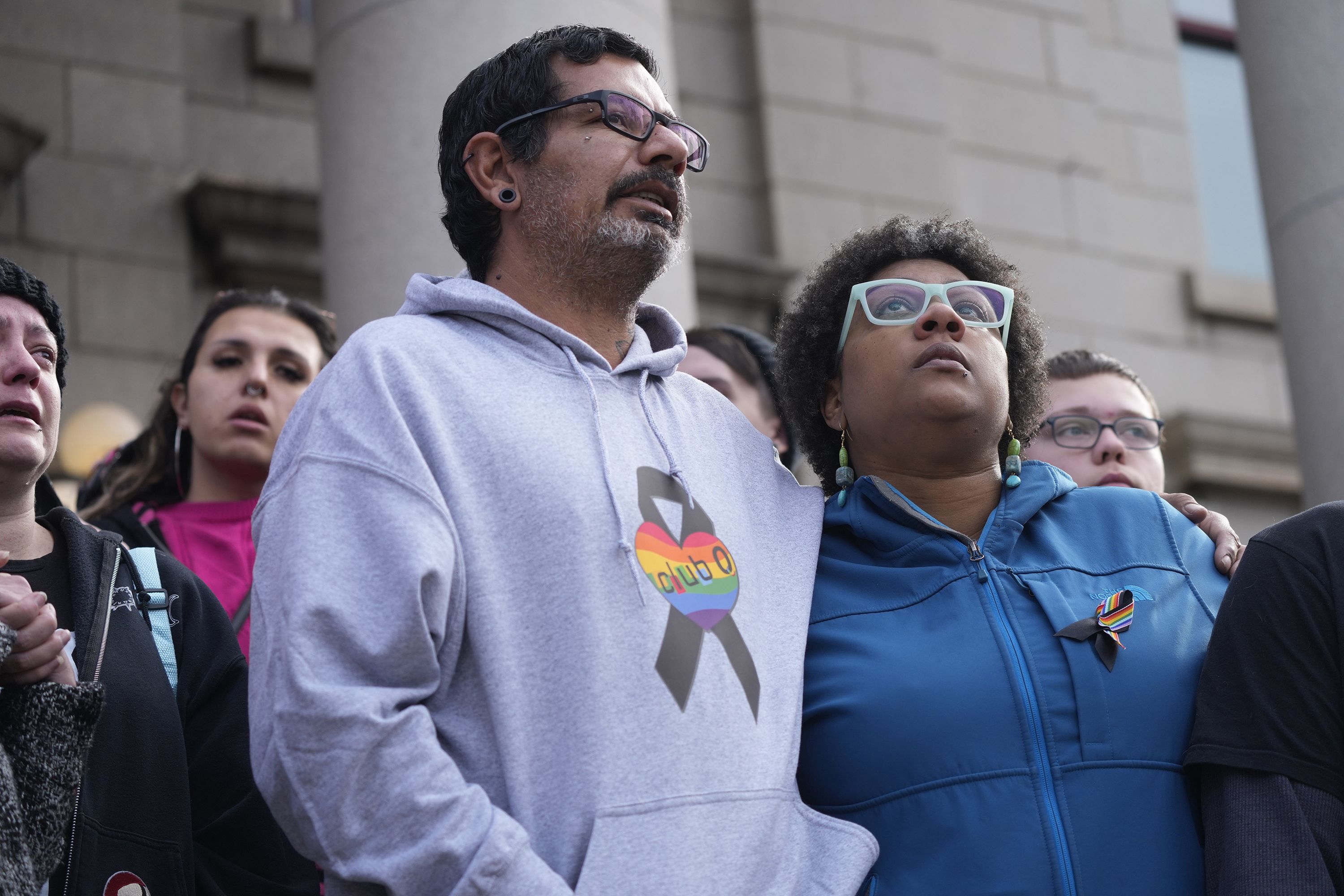 Juan Chavez, left, hugs Jennifer Horn as they join other Club Q supporters outside the Colorado Springs City Hall on Wednesday.