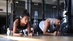 Portrait of sports couple on a plank position.
