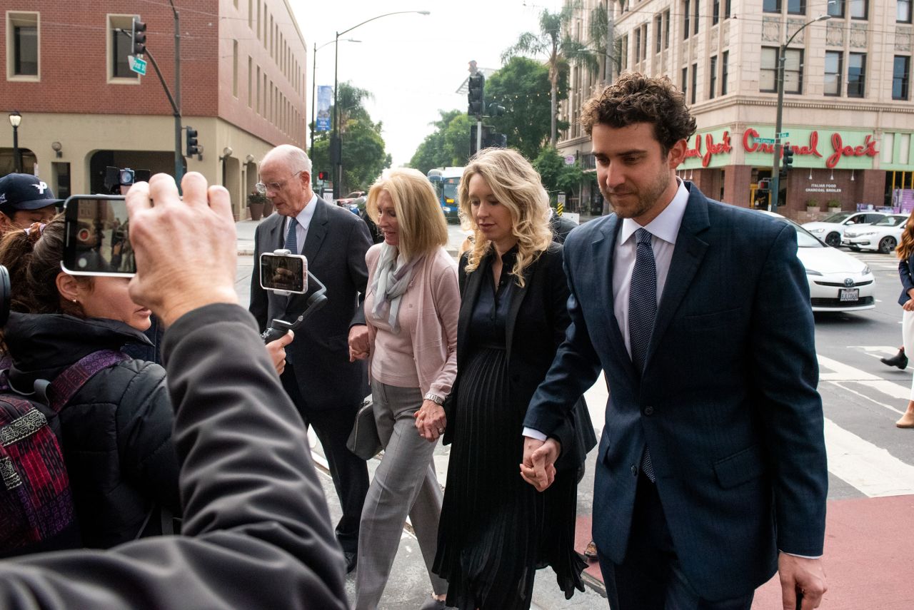 Elizabeth Holmes arrives at a federal court in San Jose, California, with her parents and her partner, Billy Evans, on Friday, November 18. Holmes was <a href="https://www.cnn.com/2022/11/18/tech/elizabeth-holmes-theranos-sentencing" target="_blank">sentenced to more than 11 years in prison</a> for defrauding investors while running the failed blood testing startup Theranos.