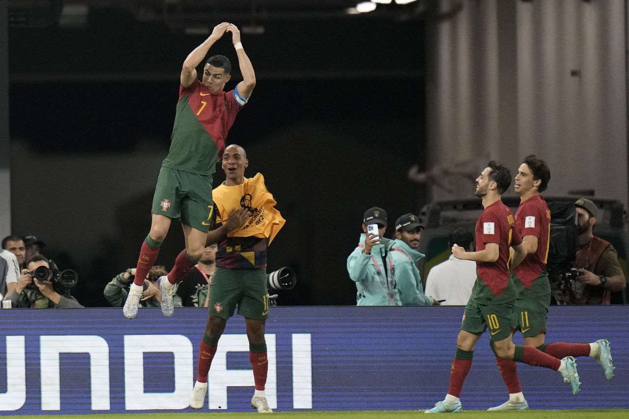 Portugal's Cristiano Ronaldo does his trademark goal celebration Thursday, November 24, after converting a penalty against Ghana to become the <a href="https://www.cnn.com/2022/11/20/football/gallery/world-cup-2022/index.html" target="_blank">first man in history to score in five World Cups</a>. It was the first goal of a match that ended in a 3-2 Portugal win.