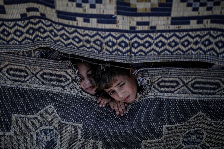 Palestinian children look out from the gap of a tent in Beit Lahia, Gaza, on Monday, November 21.