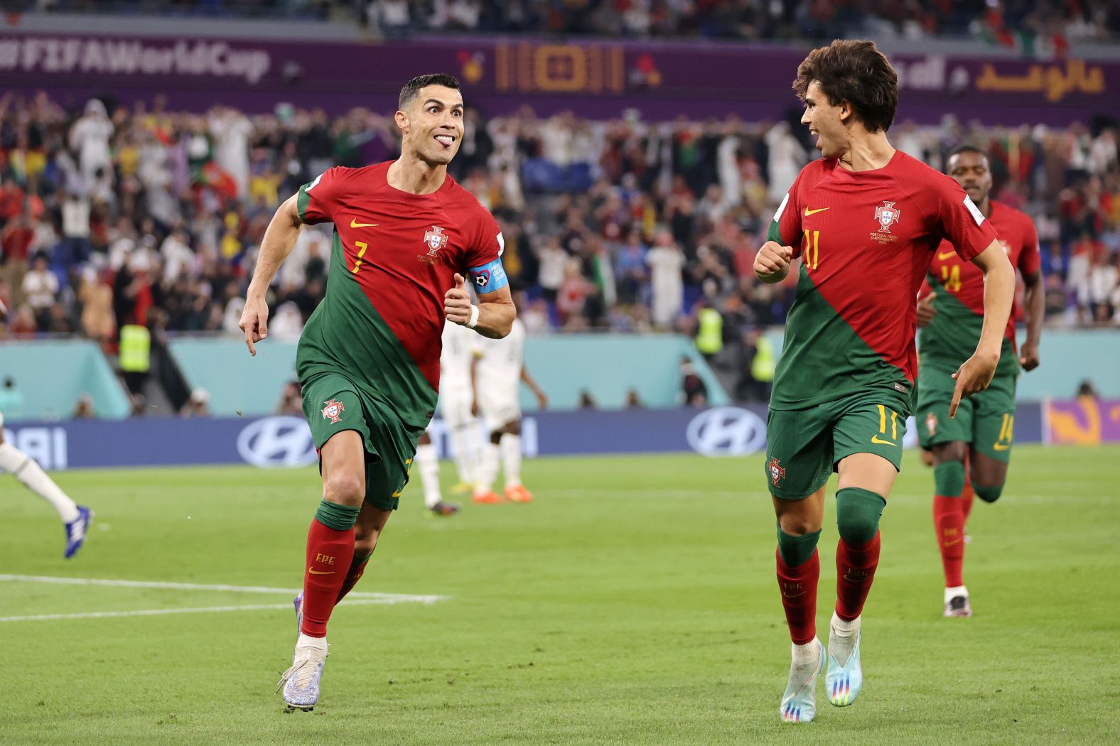 Ronaldo makes a face as he celebrates his goal with teammate João Félix.