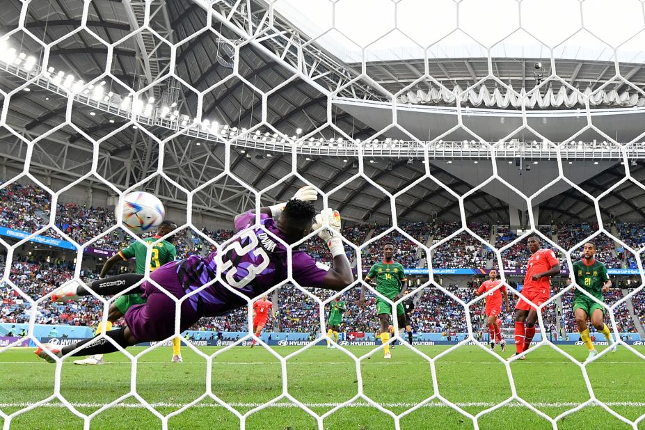Switzerland's Breel Embolo, second from right, shoots past Cameroon's Andre Onana to score the only goal of their match.