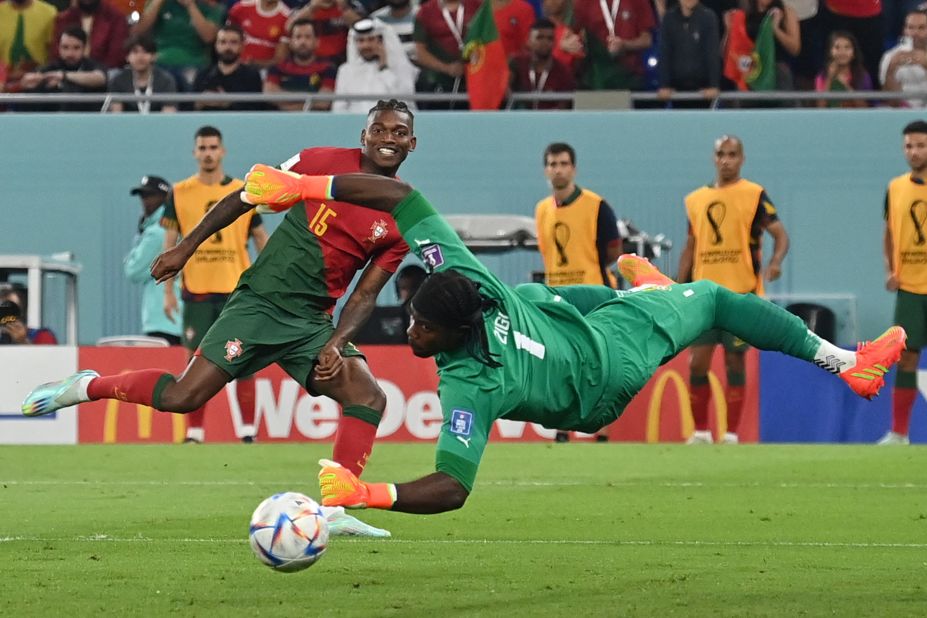 Rafael Leão smiles as his shot goes by Ghana goalkeeper Lawrence Ati-Zigi for Portugal's third goal.