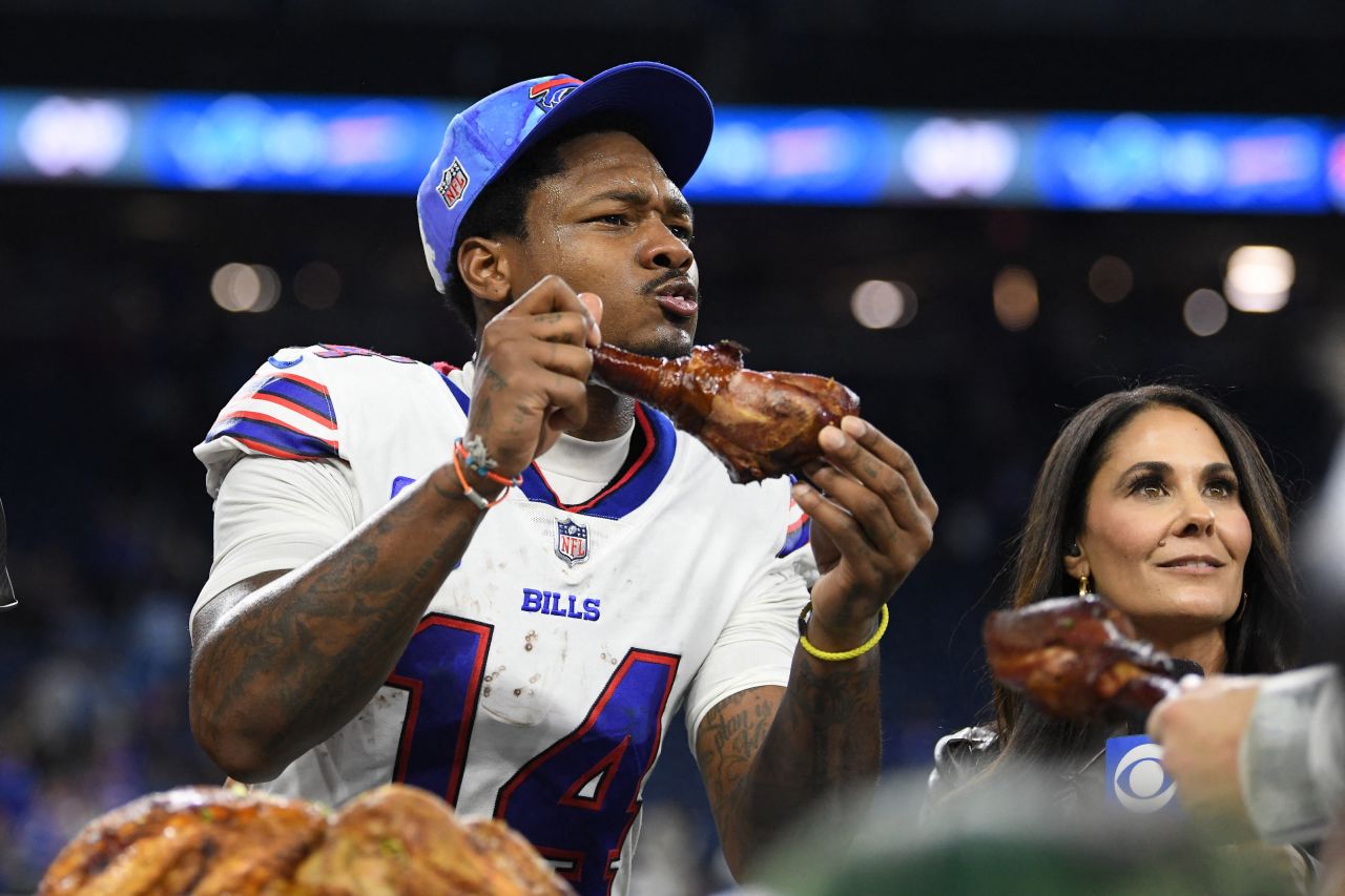 Buffalo Bills wide receiver Stefon Diggs bites into a turkey leg after a Thanksgiving Day game against the Detroit Lions.