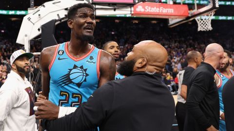 Deandre Ayton of the Phoenix Suns is restrained after being pushed to the court Tuesday. 