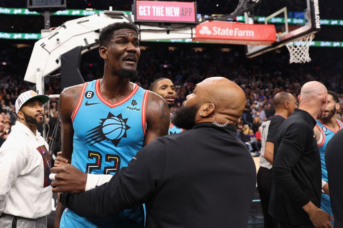 Deandre Ayton of the Phoenix Suns is restrained after being pushed to the court Tuesday. 